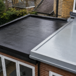 EPDM and GRP flat roofing compared on adjoining home extensions in Surrey